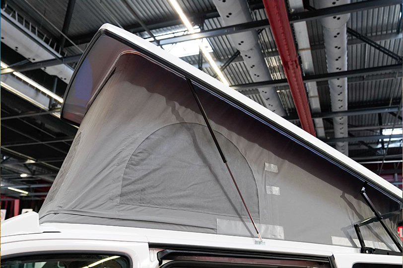 Pop up roof inside a showroom on top of a white van