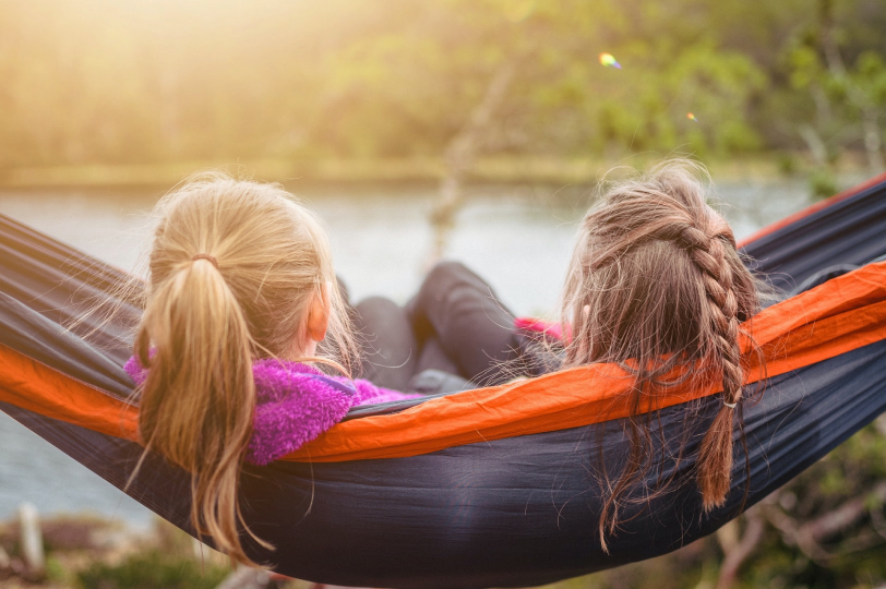 2 kids sat in a hammock