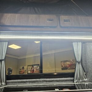interior shot of a vw t6.1 transporter showing the hop, storage, and the curtains over the windows