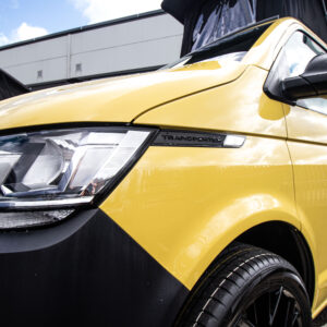T6.1 Volkswagen Transporter Startline Campervan – Sunny Yellow – 24 Plate – A1196 front angled view close up of transporter brand
