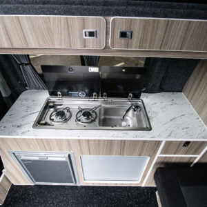 Overview of the sink and hob with hatches open of the Ice Blue Campervan