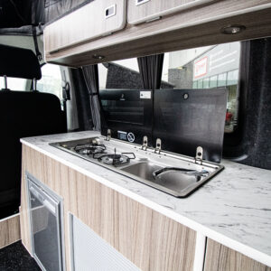 Angled view of the sink and hob with hatches open of the Ice Blue Campervan
