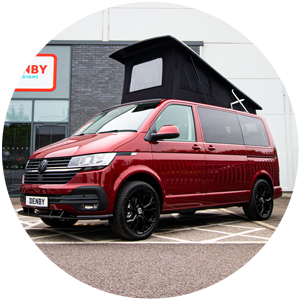 red vw camper in a circle outside showroom