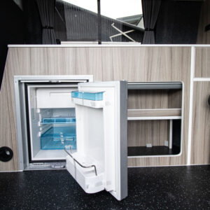 close up shot of the fridge with the door open in a transporter highline campervan