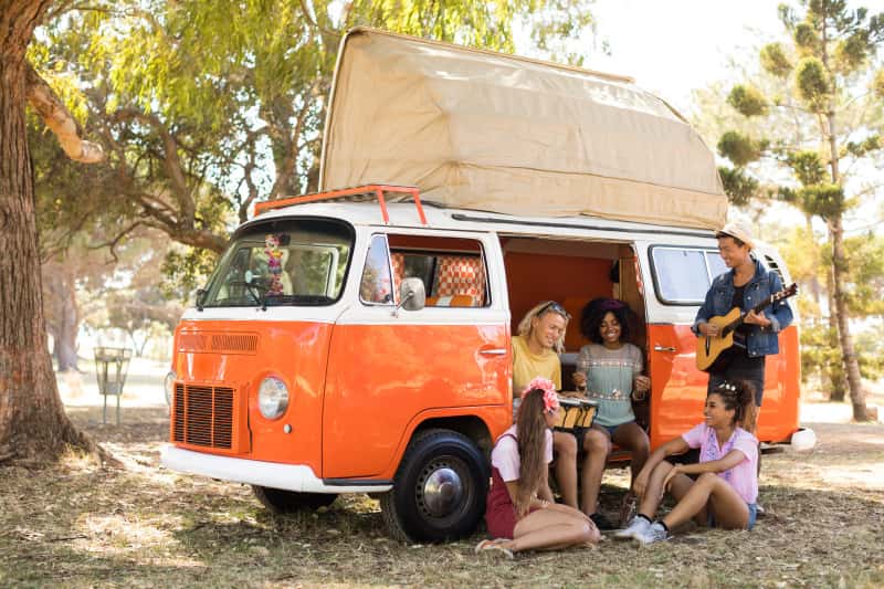 orange campervan with people inside