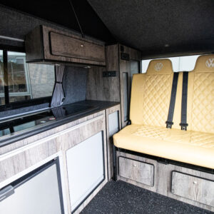 Interior view from the rotated front seats towards the rear of the transporter campervan