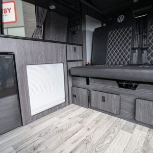 Balmoral Deluxe SWB - T6.1 Volkswagen Transporter Highline Campervan – Pure Grey – 23 – A1267 angled view of the storage and lower seats