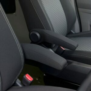 Close-up of two seats in the Deluxe SWB 2025 Volkswagen Transporter T7 DSG Auto Commerce Plus Campervan (Warm Green, Stock A1449), featuring gray patterned upholstery, black armrests between them, and visible seatbelt buckles.